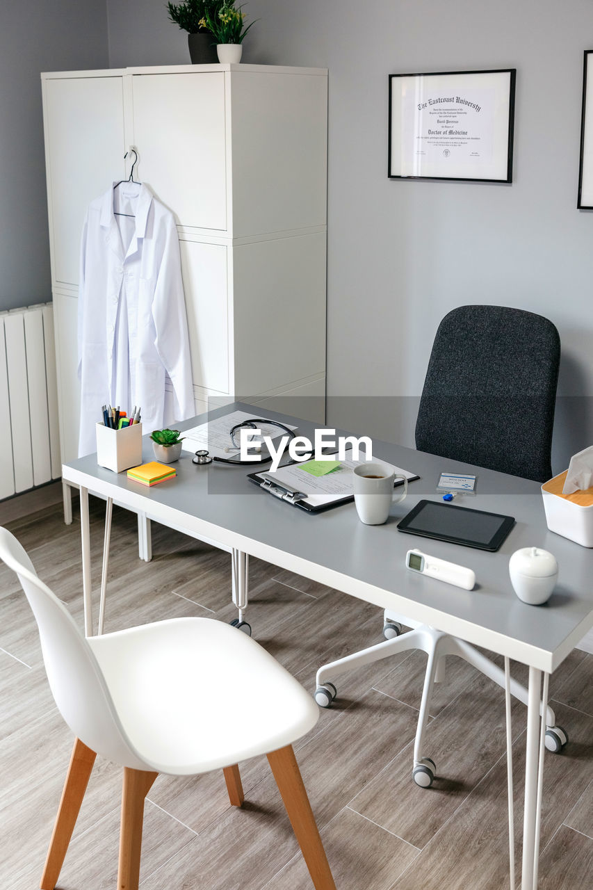 Empty chairs and tables on hardwood floor at home
