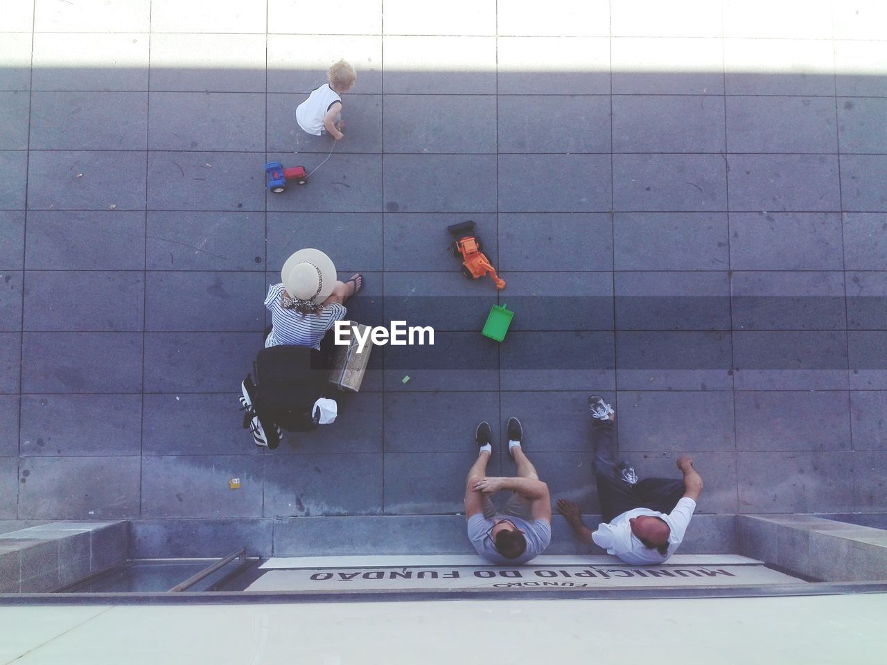 HIGH ANGLE VIEW OF MAN STANDING ON TILED FLOOR