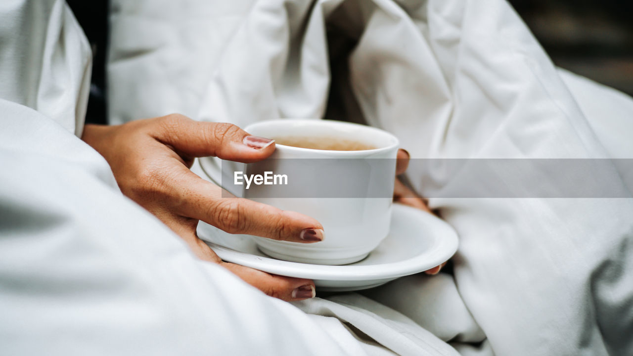 Woman holding coffee cup