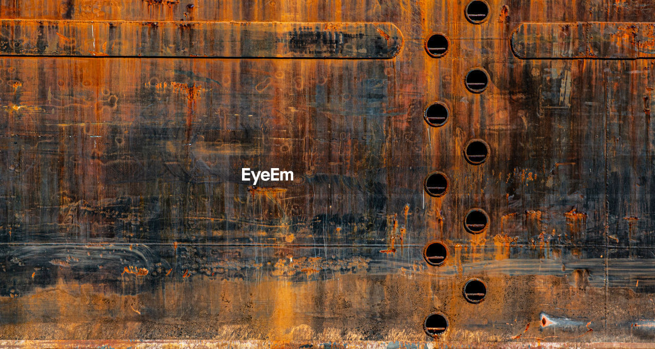 Full frame shot of old metal structure in lake