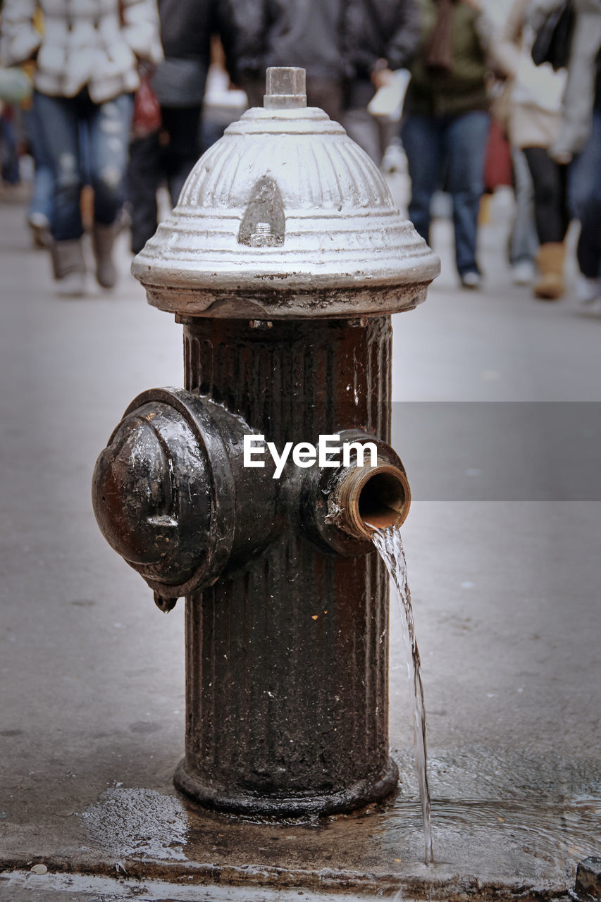 CLOSE-UP OF FIRE HYDRANT ON FOOTPATH