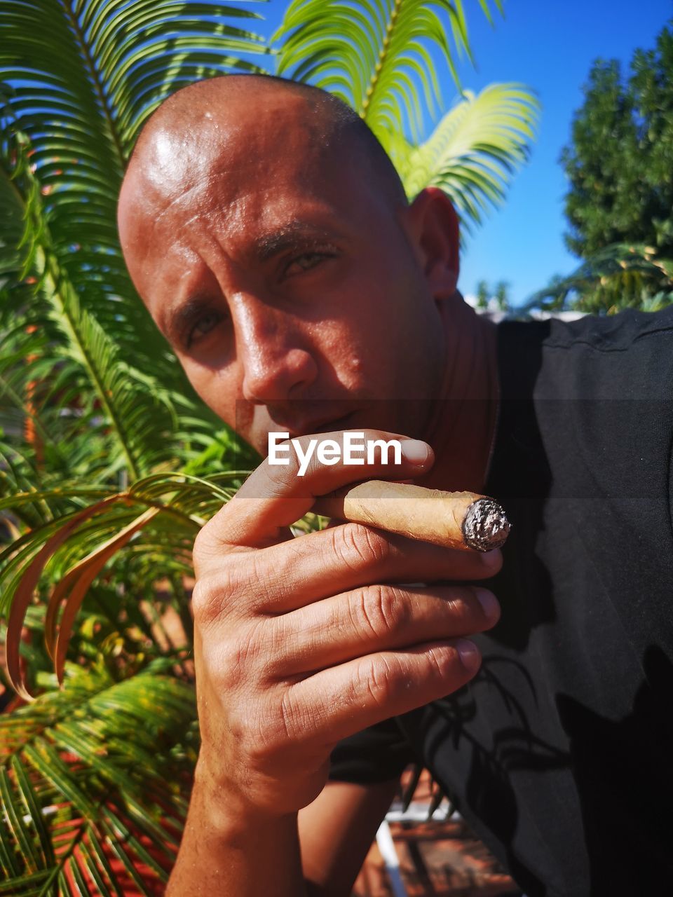 Close-up portrait of man smoking cigar