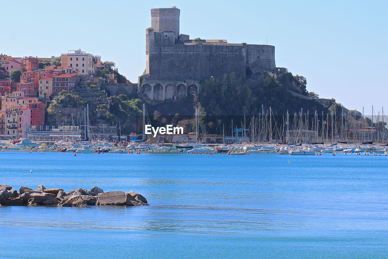 View of building by sea against clear sky