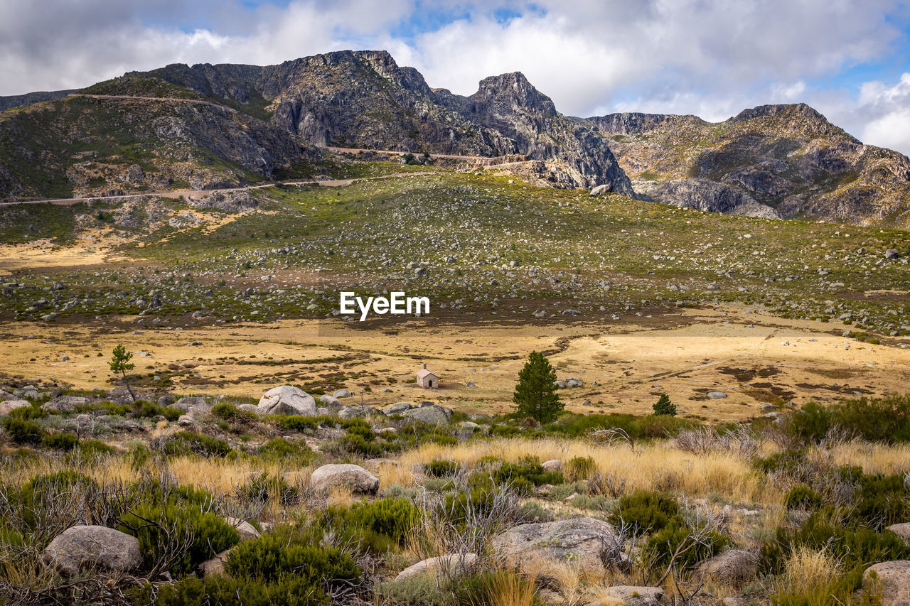 Scenic view of landscape and mountains against sky