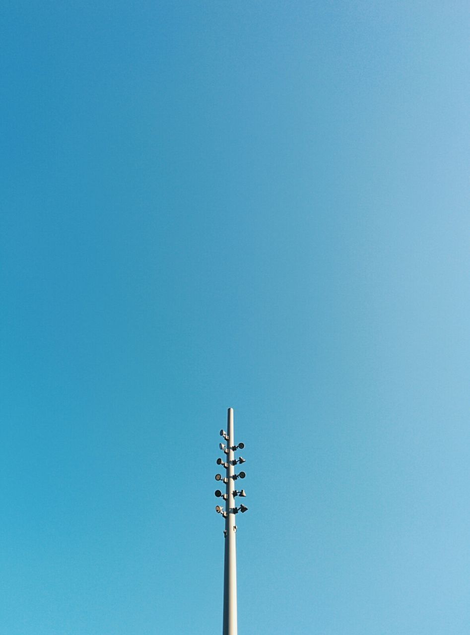 Tower with lights against clear blue sky