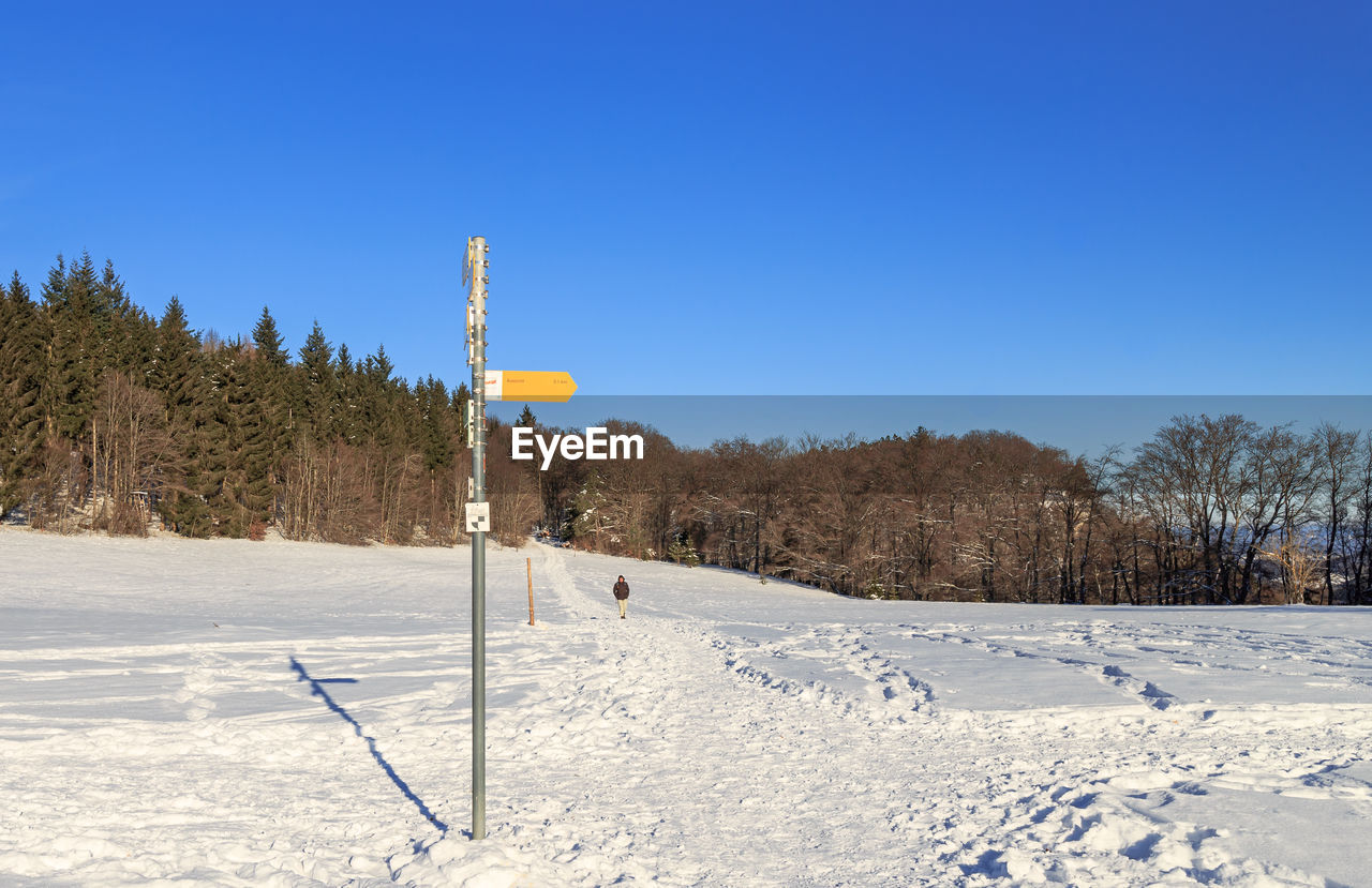 SNOW COVERED FIELD AGAINST CLEAR SKY