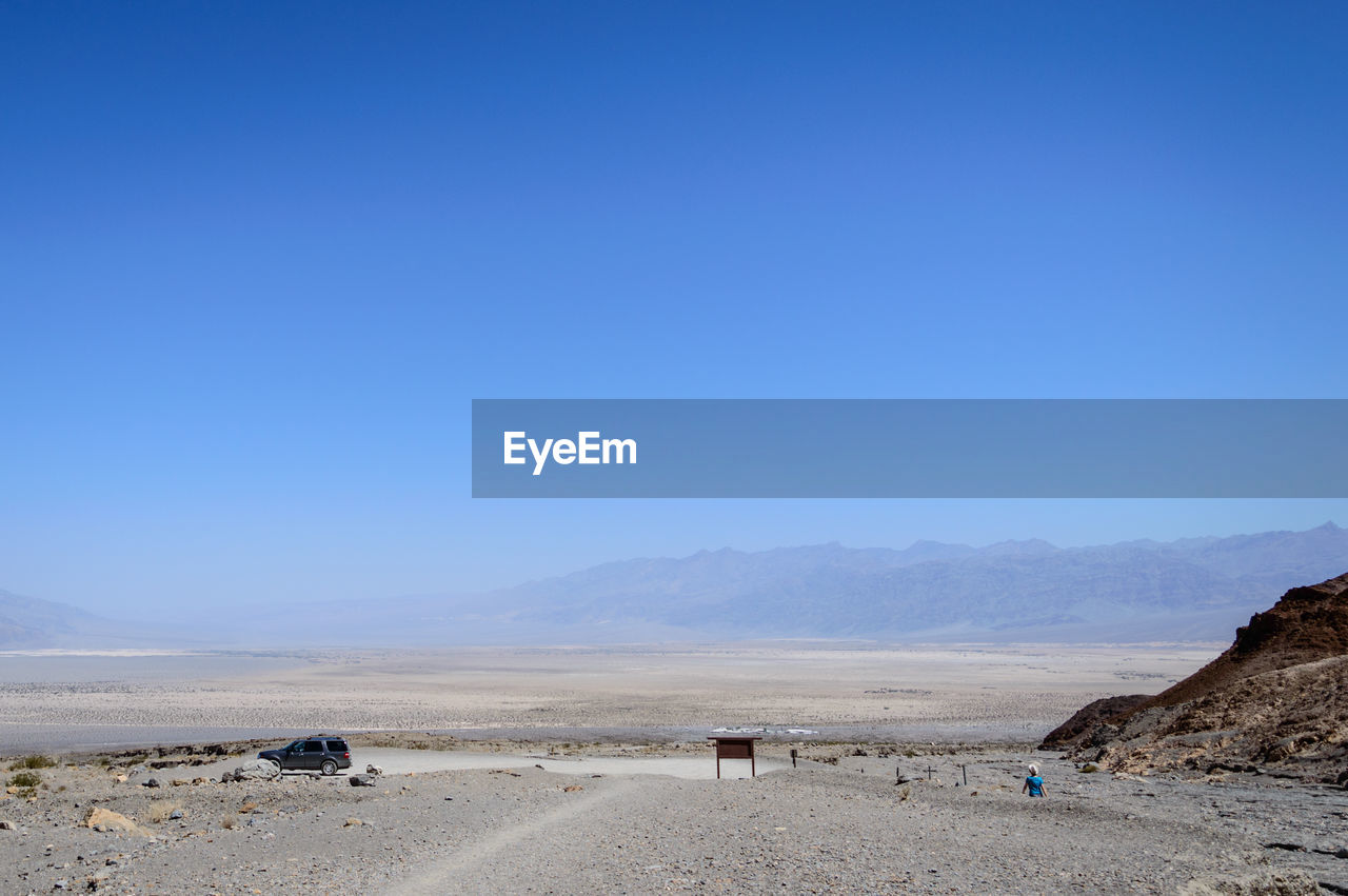 Scenic view of mountains against clear blue sky