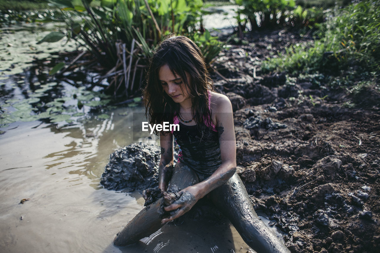 Young girl playing in the mud in queensland australia