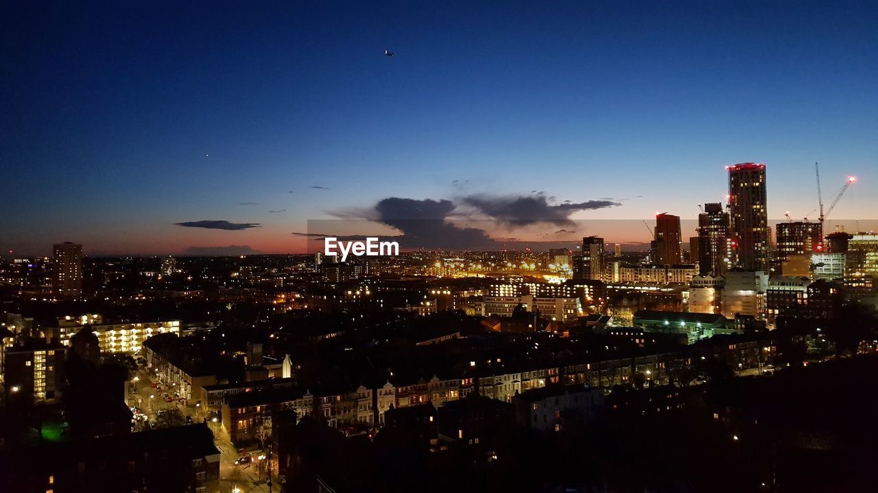 ILLUMINATED CITYSCAPE AT NIGHT