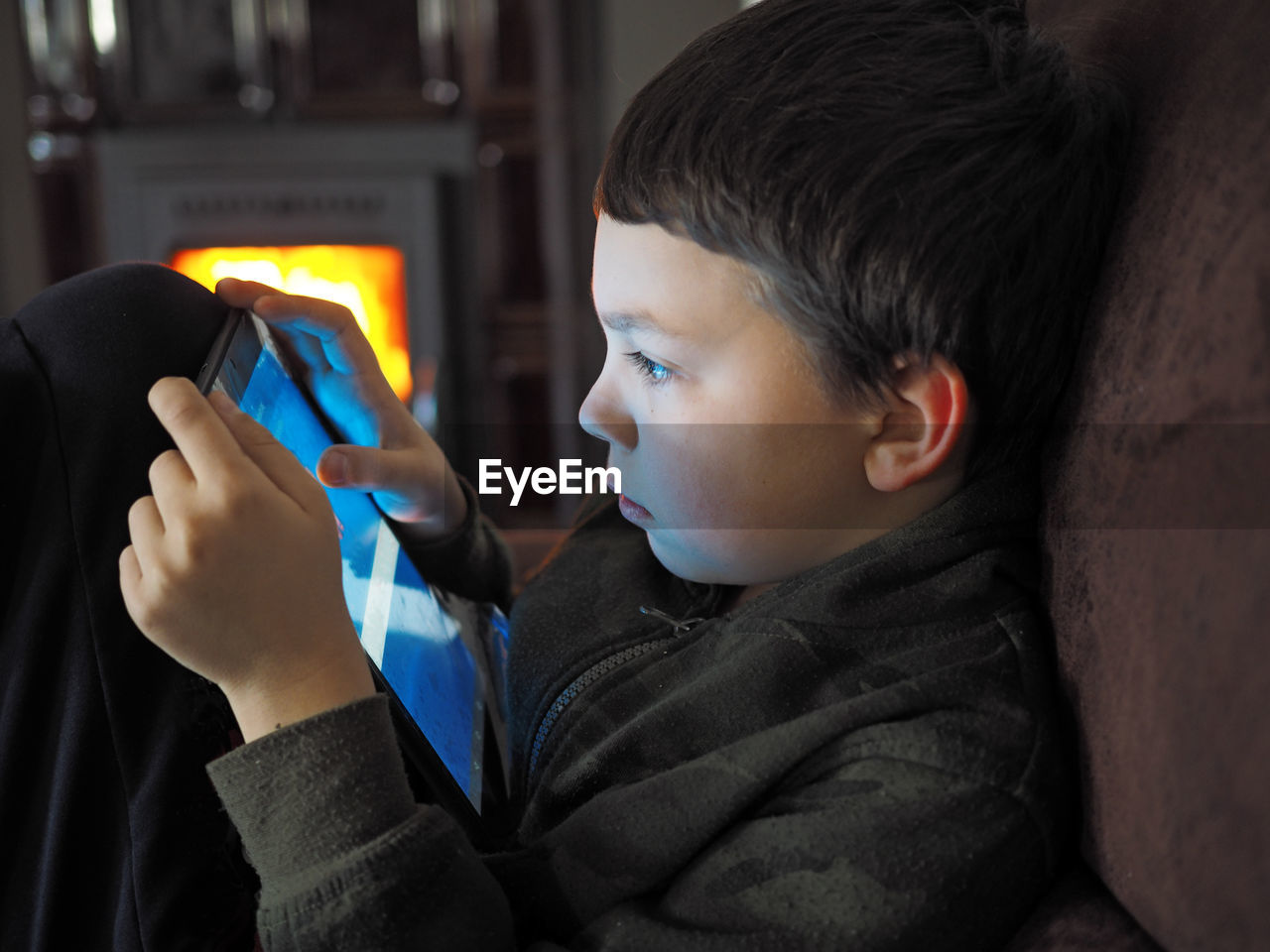 Close-up of boy using digital tablet at home