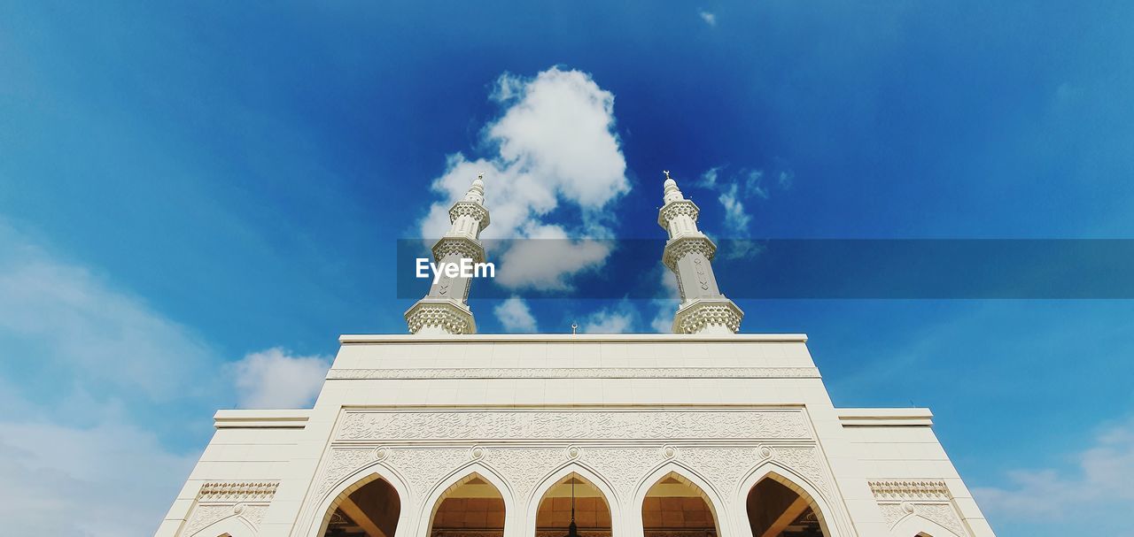 Low angle view of building against cloudy sky