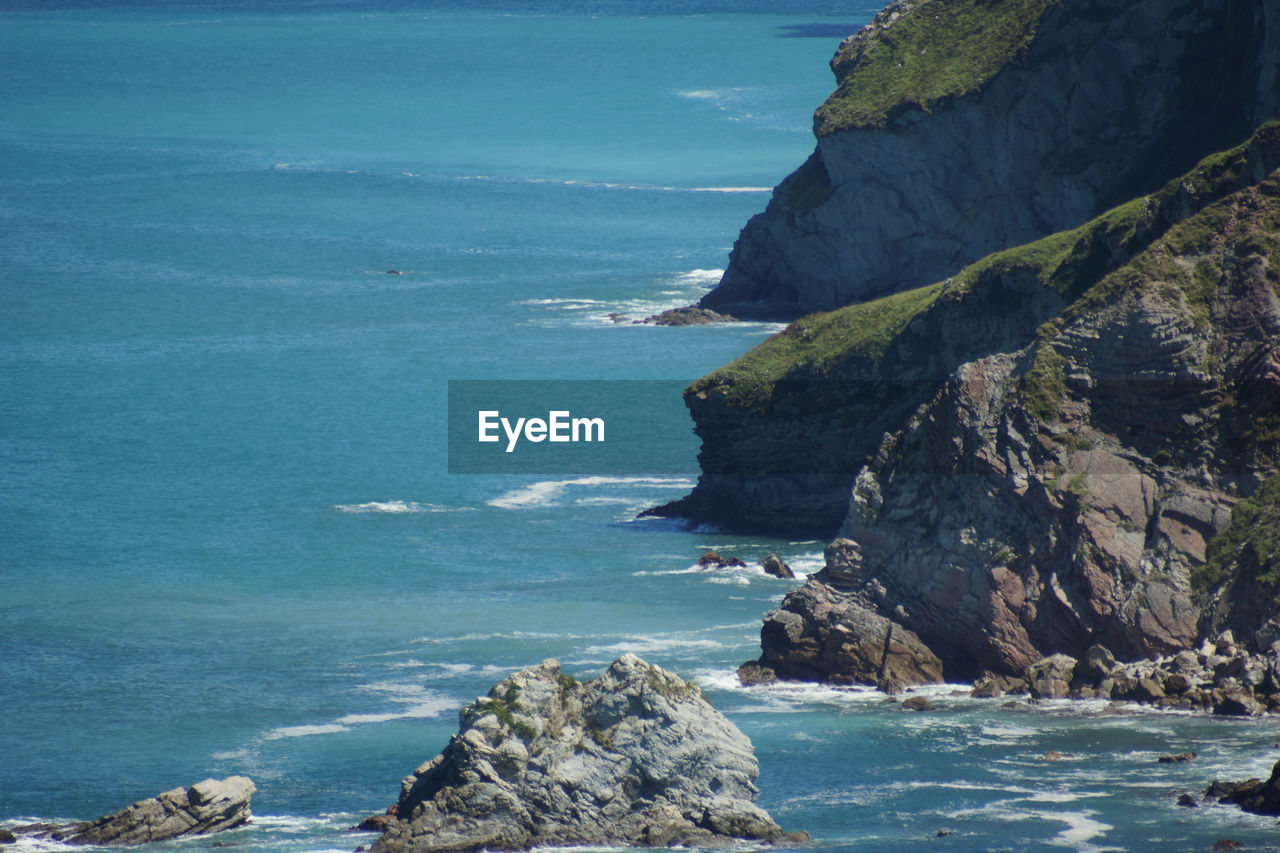 Scenic view of sea against rock formation