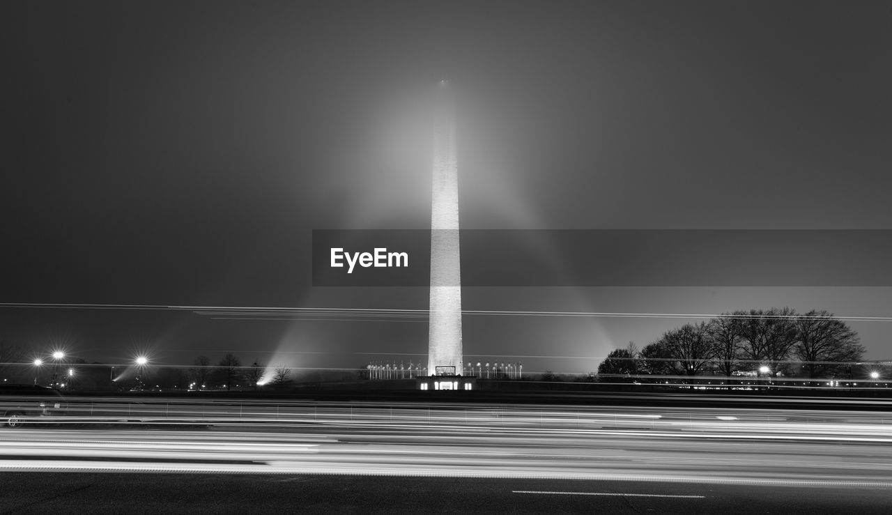 LIGHT TRAILS ON ROAD IN CITY