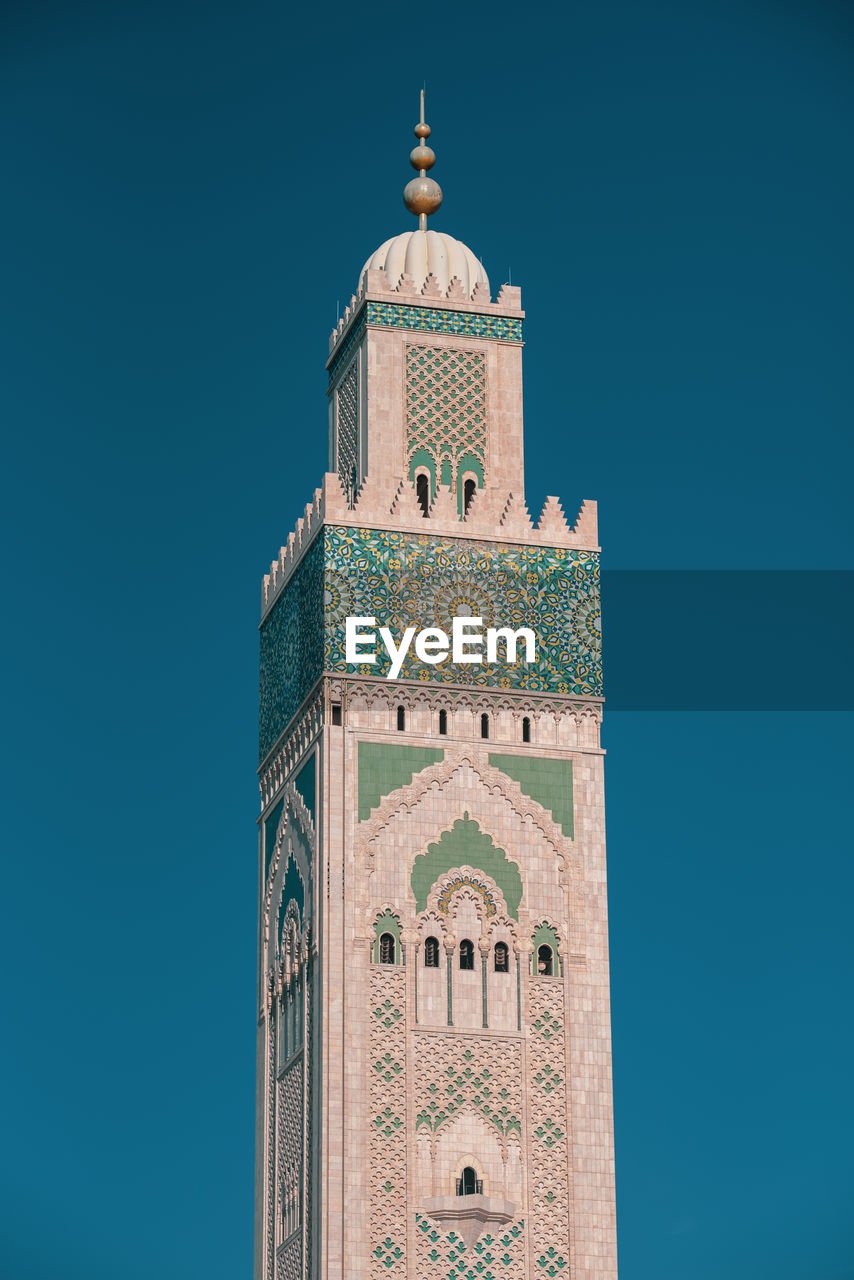 Low angle view of clock tower against blue sky