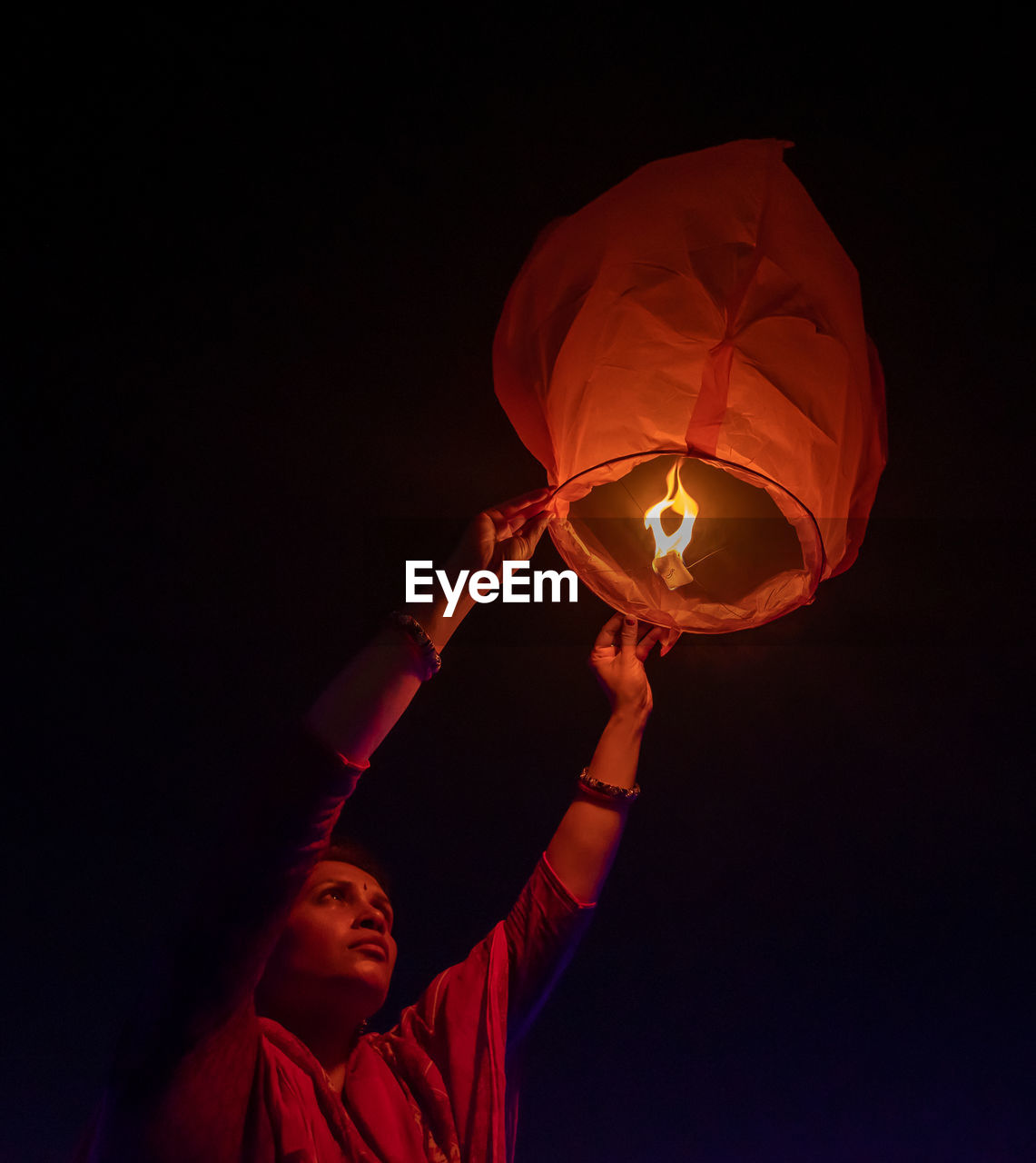 Close up of women holding sky lantern