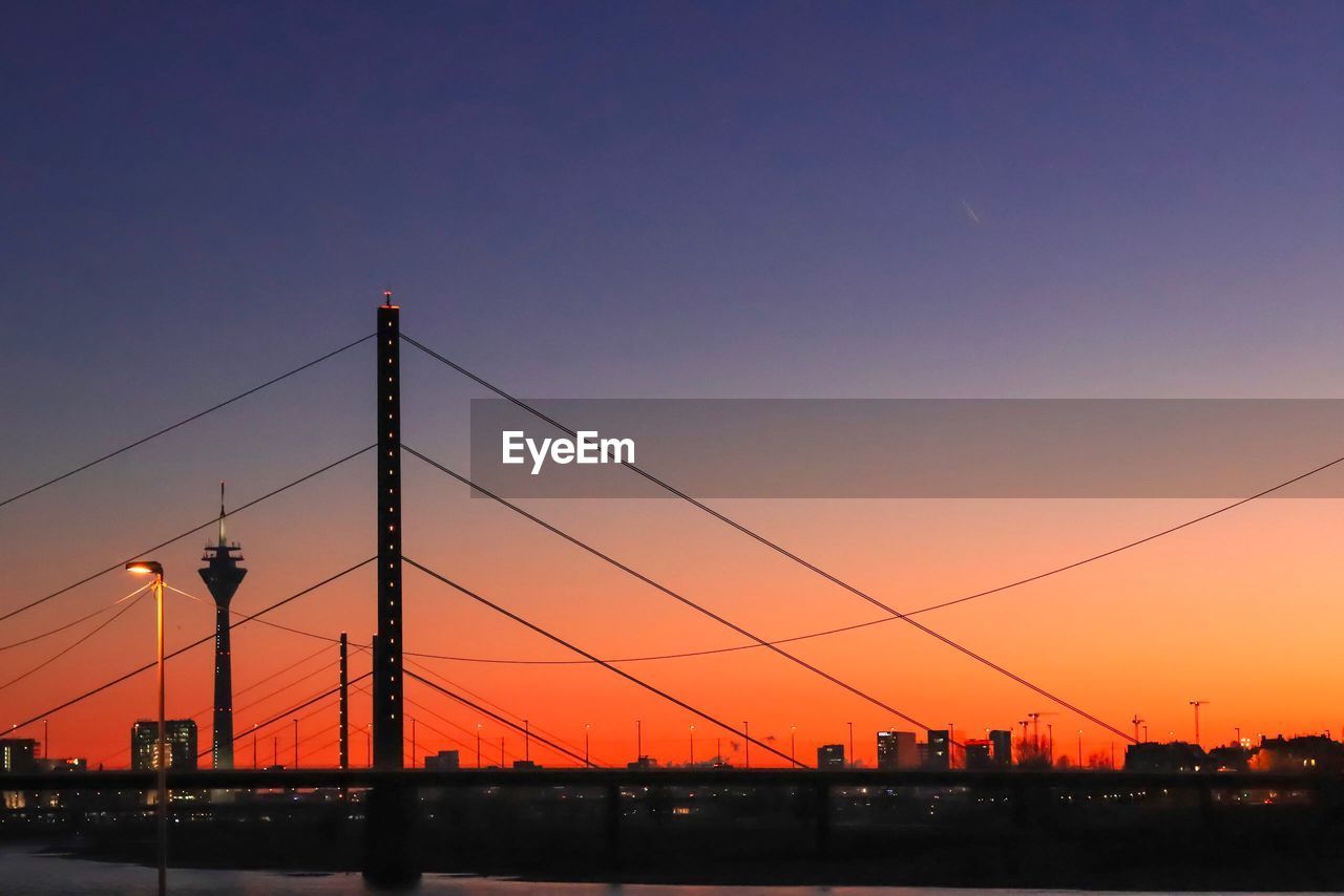 SILHOUETTE ELECTRICITY PYLON AGAINST ROMANTIC SKY DURING SUNSET