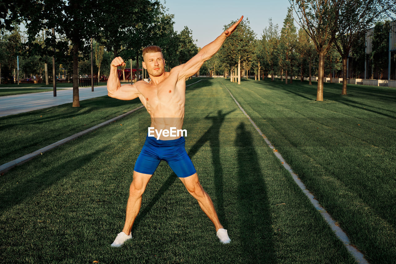 low section of man exercising on field