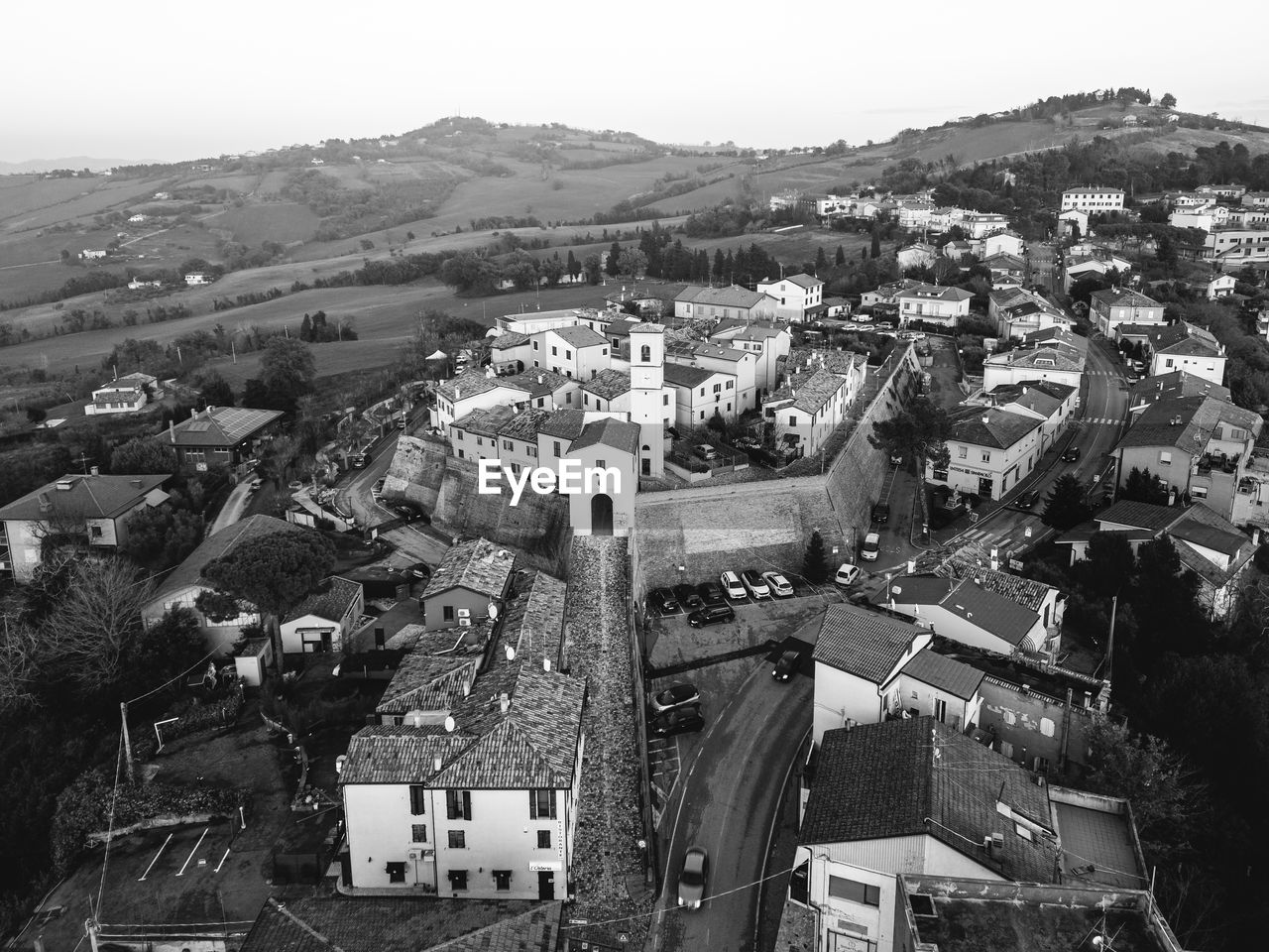 architecture, building exterior, built structure, city, aerial photography, high angle view, black and white, building, cityscape, monochrome photography, residential district, monochrome, residential area, no people, nature, town, suburb, house, sky, day, outdoors, aerial view, roof, landscape, transportation, environment, city life, travel destinations, bird's-eye view