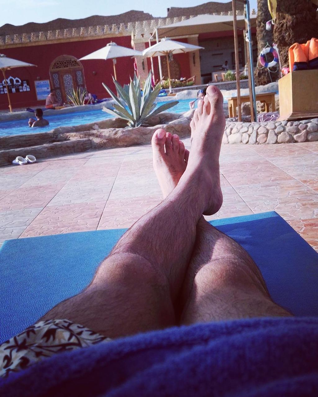 WOMAN RELAXING IN SWIMMING POOL