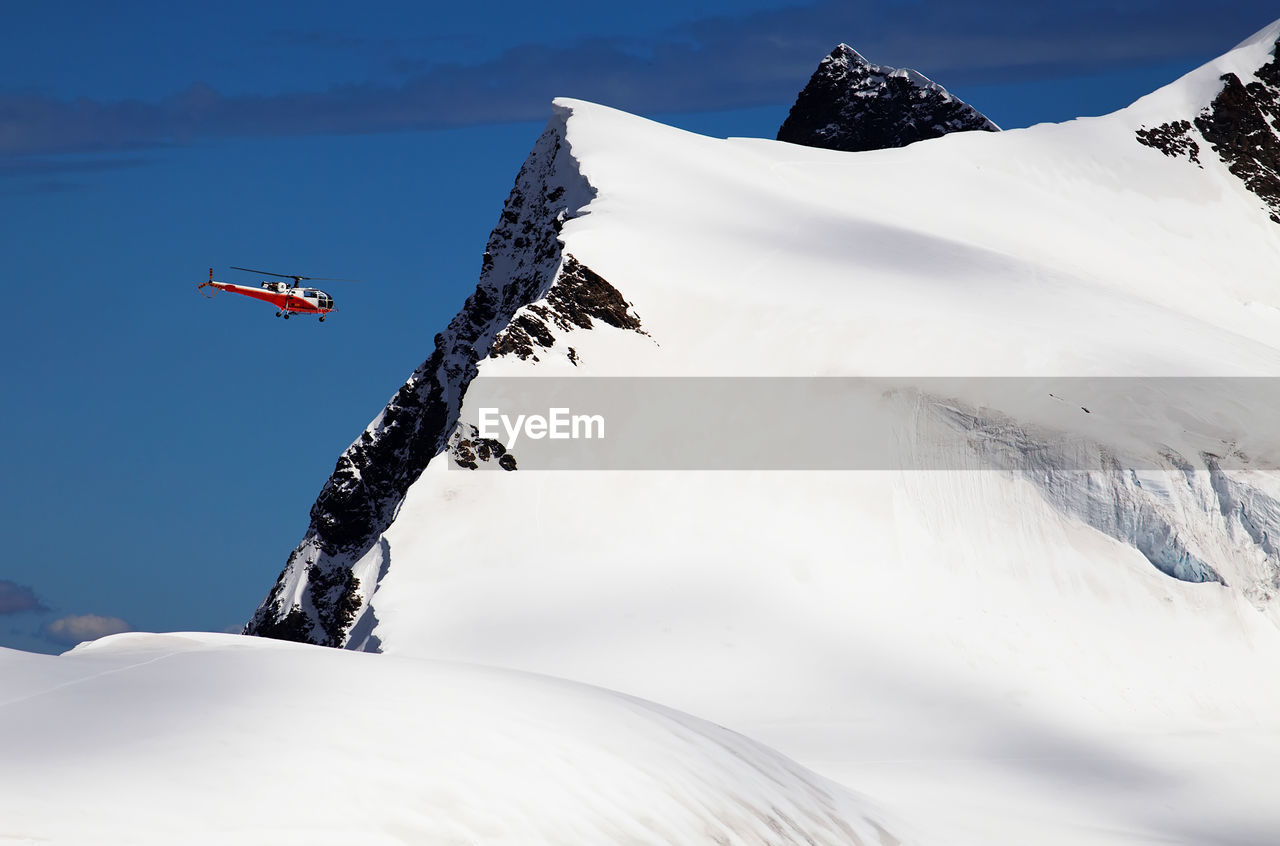 SNOW COVERED MOUNTAIN AGAINST SKY