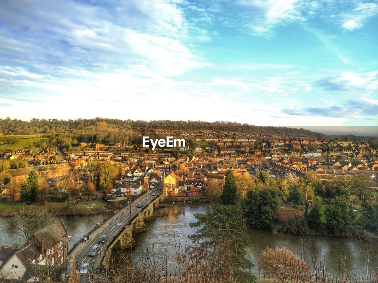 High angle view of river amidst buildings against sky