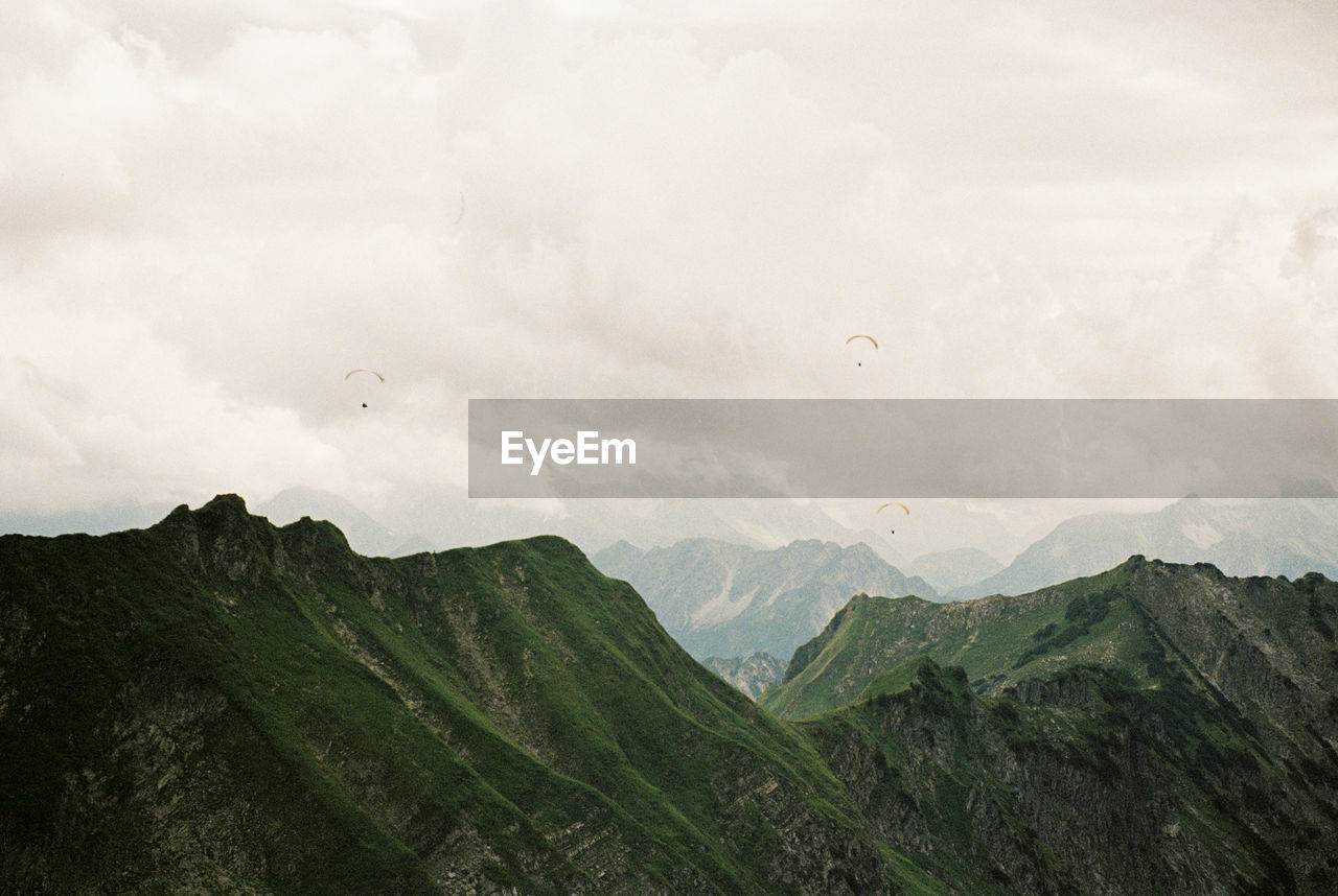 Scenic view of paragliders in the mountains near oberstdorf. shot on 35mm kodak portra 800 film.