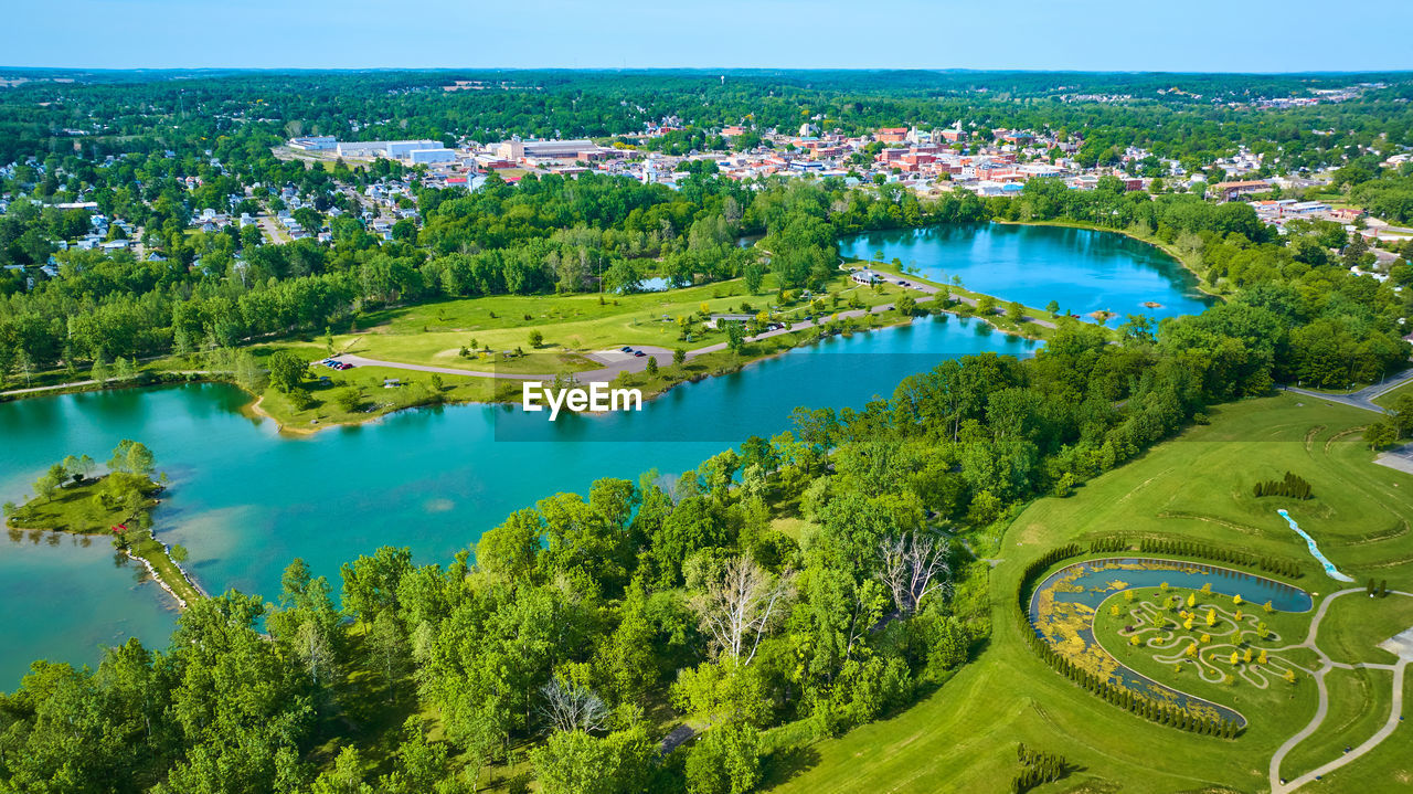 high angle view of river amidst trees against sky