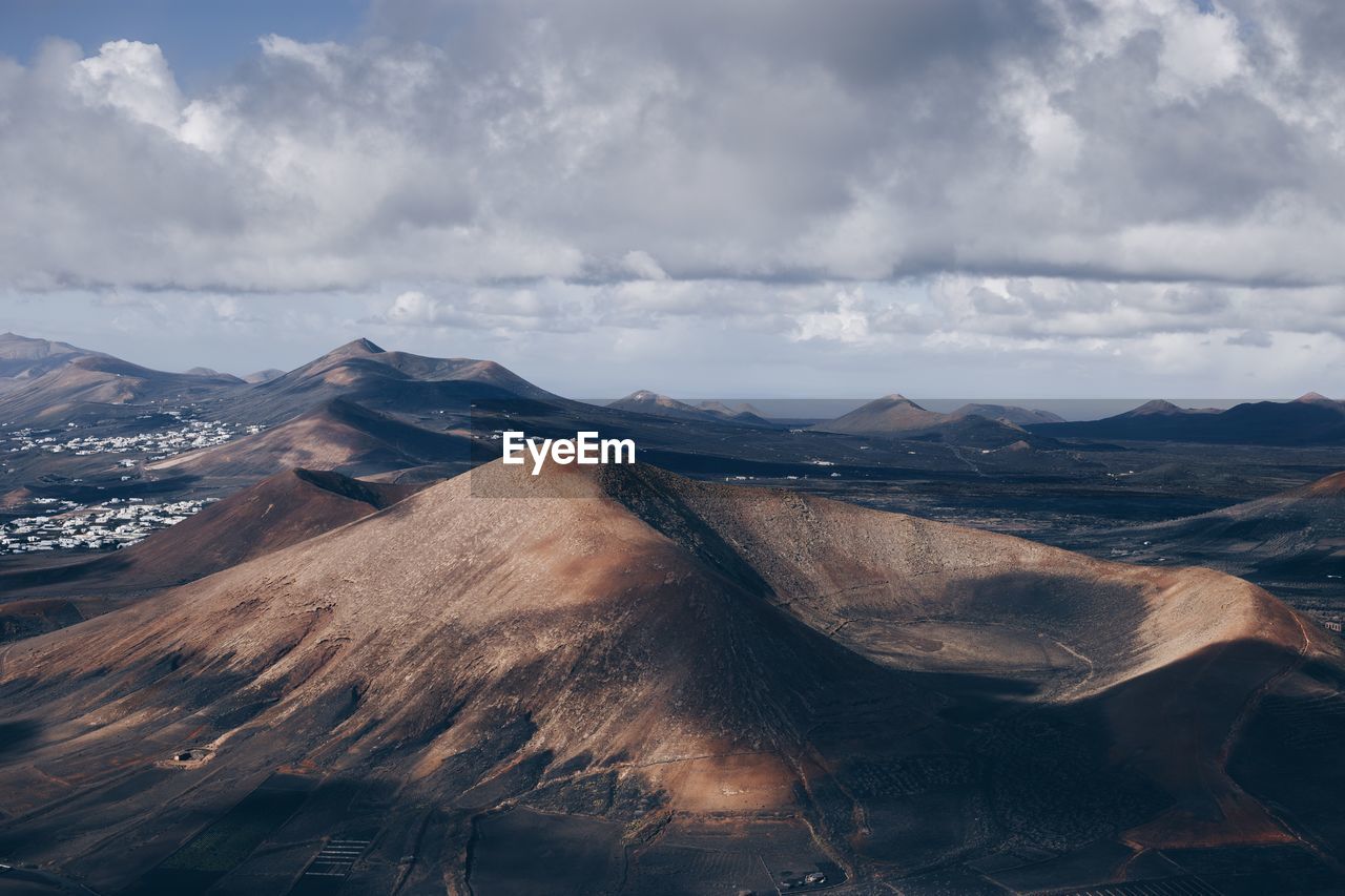 Panoramic view of volcanic landscape against cloudy sky