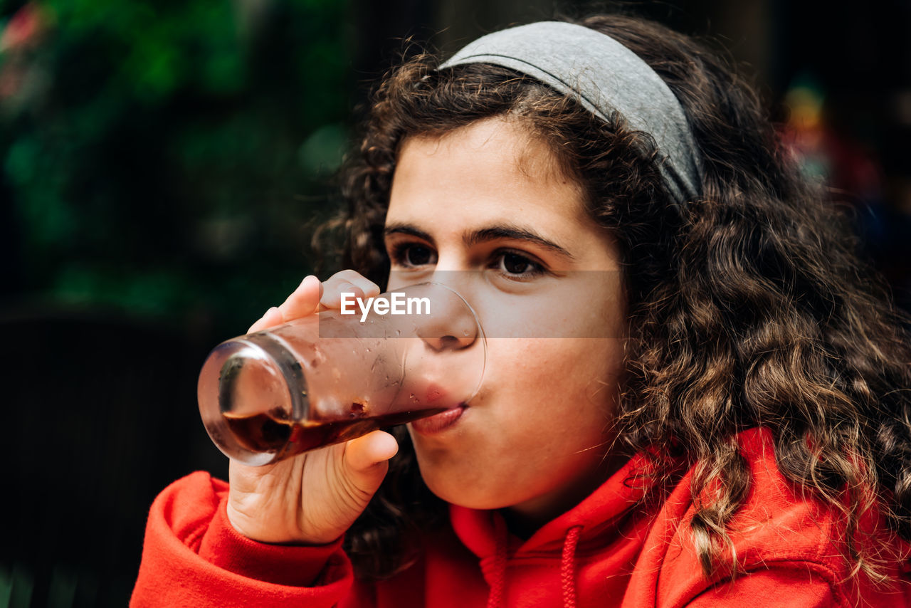Close-up portrait of girl drinking