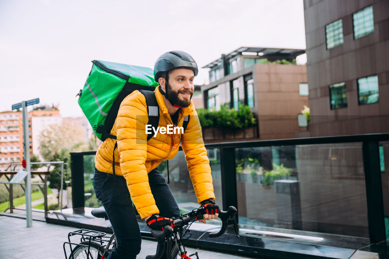 Man riding bicycle on street in city