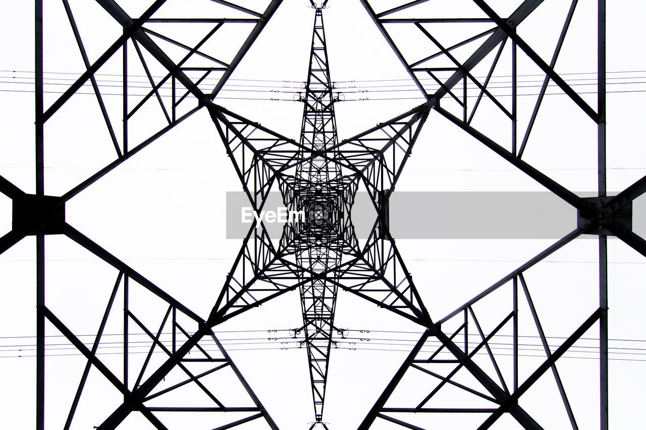 From below black and white close up of energy tower creating abstract background geometric shapes