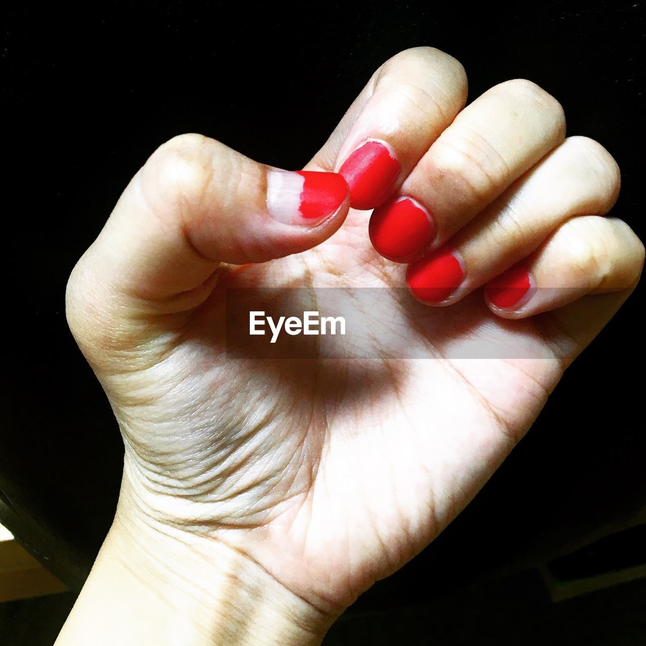 CLOSE-UP OF WOMAN HAND WITH RED LIGHT