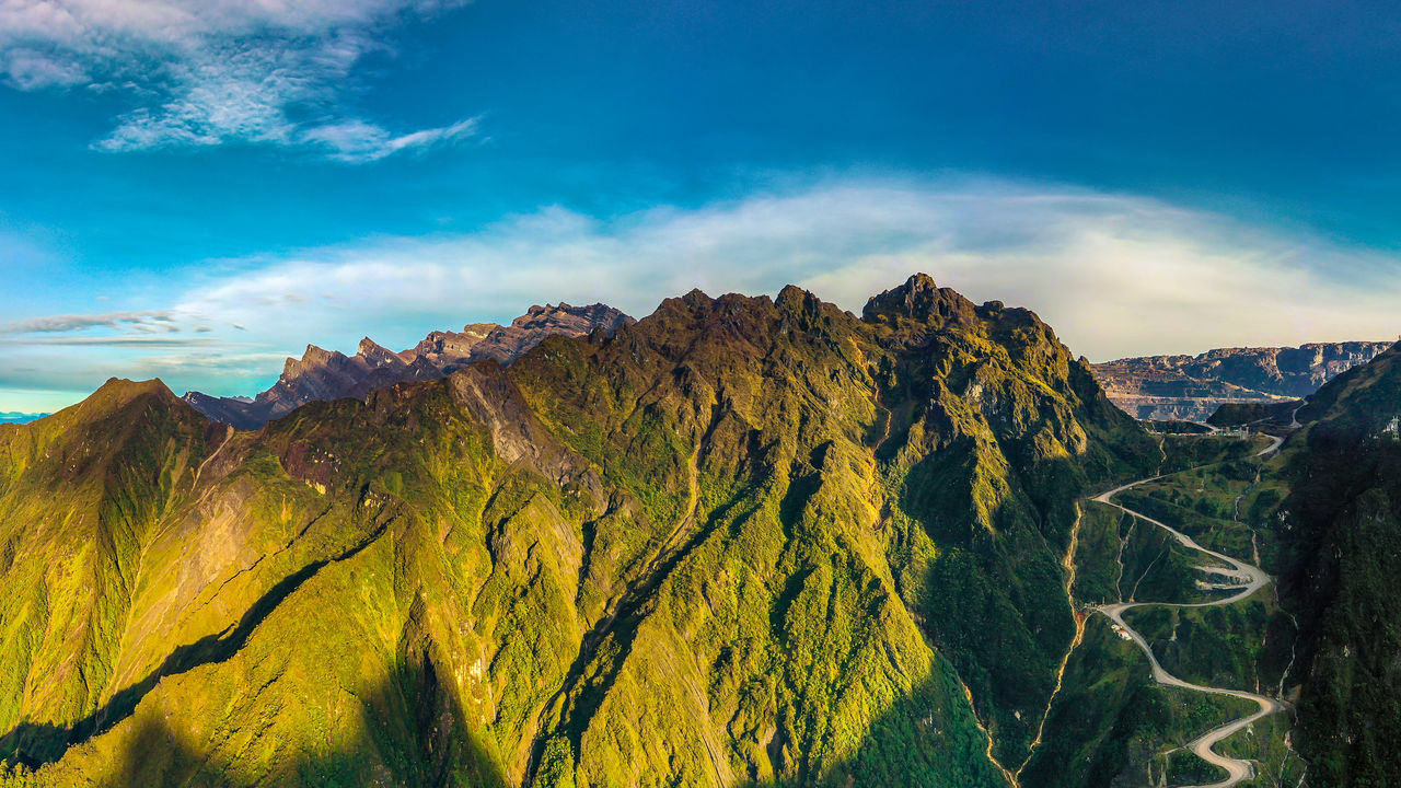 Scenic view of mountain against cloudy sky