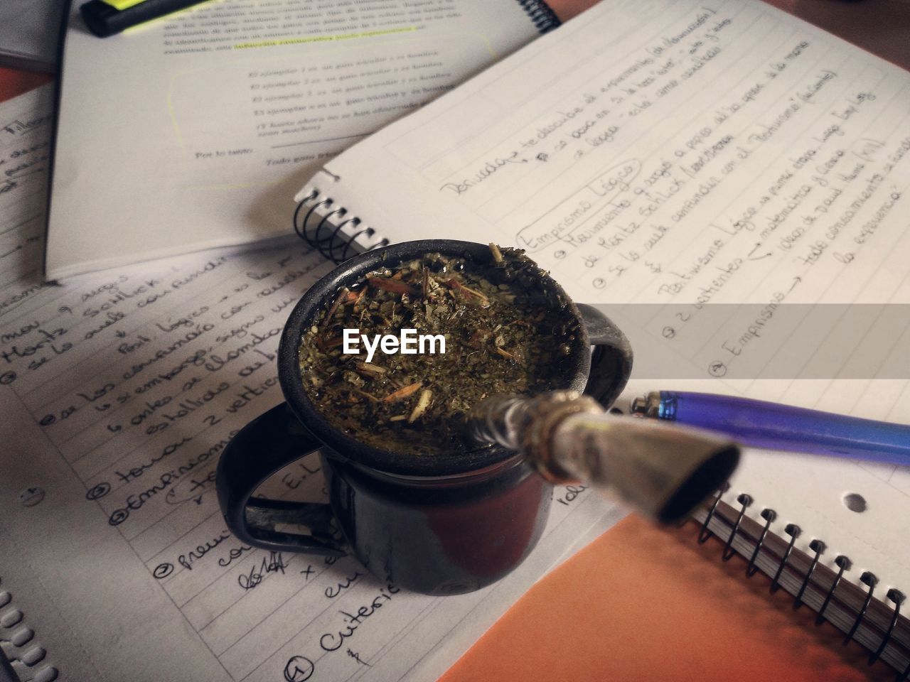 High angle view of yerba mate on open books