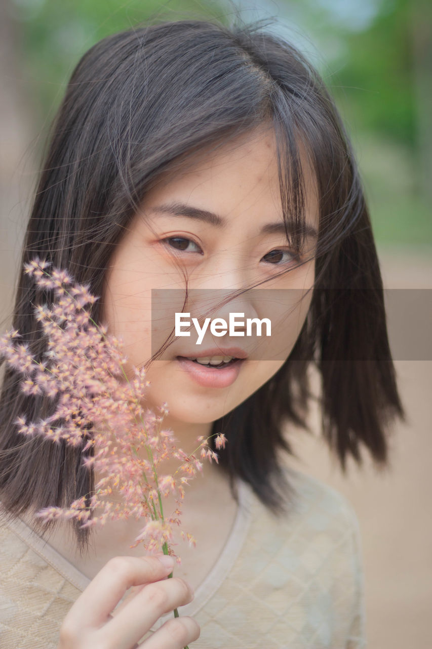 Portrait of smiling girl with pink flowers