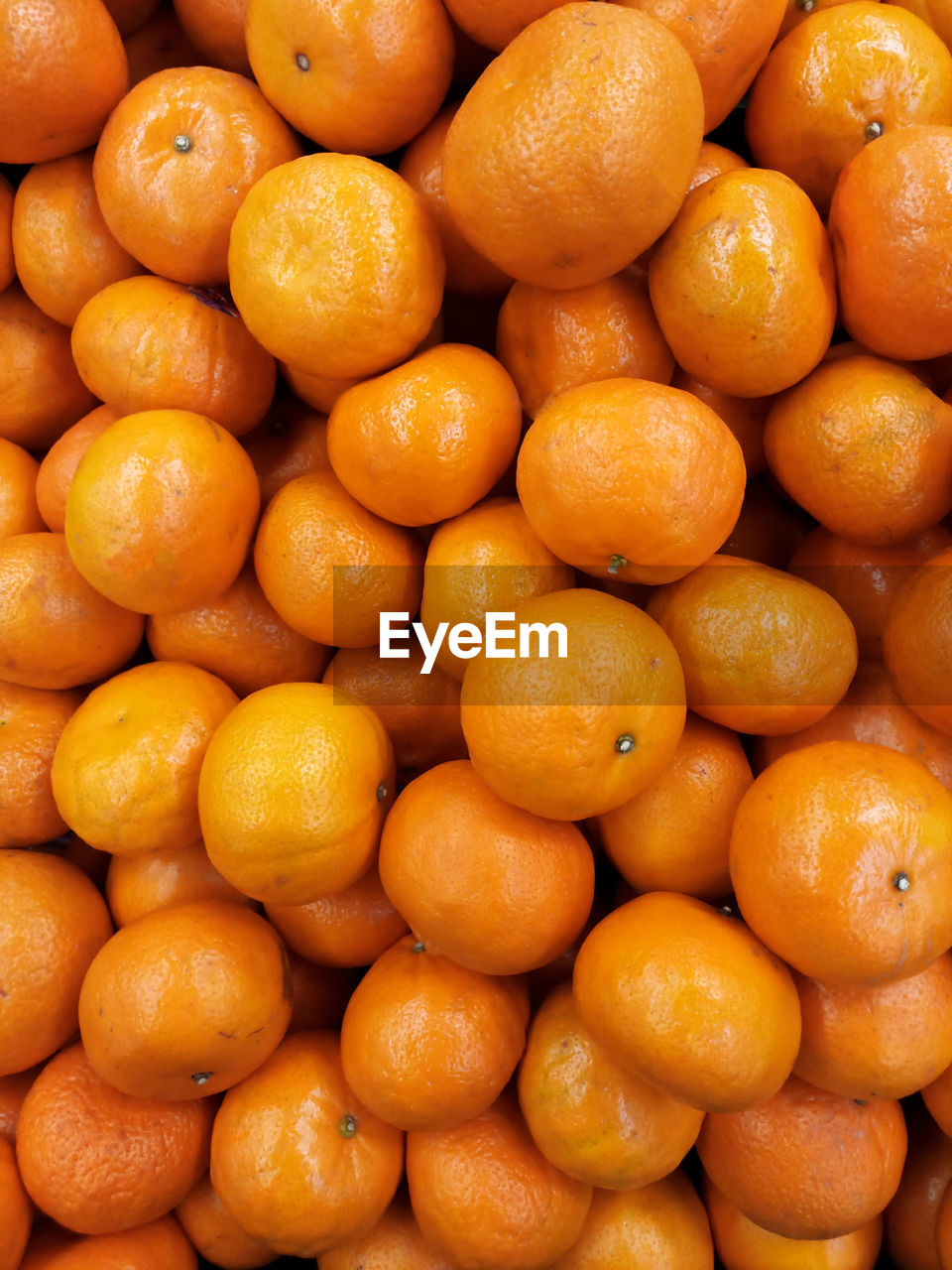 Piles of fresh oranges photo taken from the top view that displays the freshness of the fruits