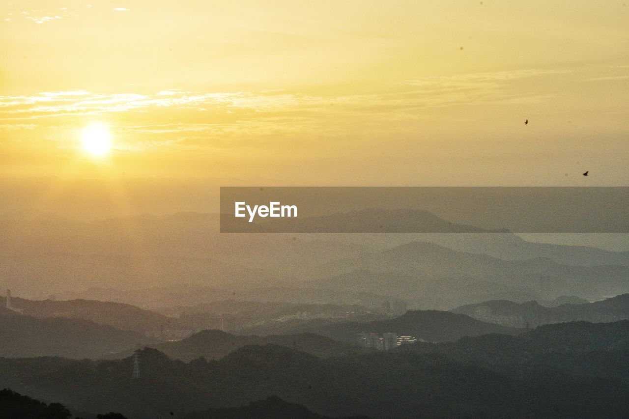 Scenic view of mountains against sky during sunset