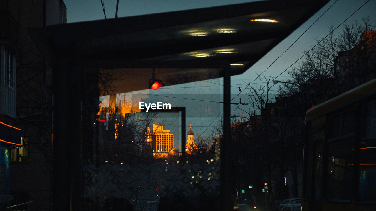 ILLUMINATED CITY BUILDINGS AT NIGHT