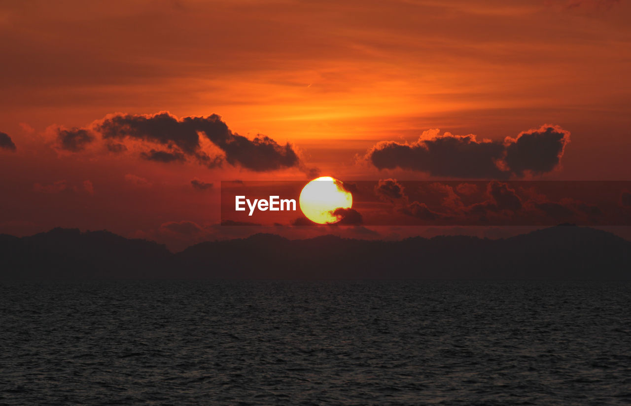 Scenic view of sea against romantic sky at sunset