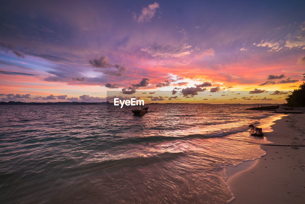 scenic view of sea at sunset