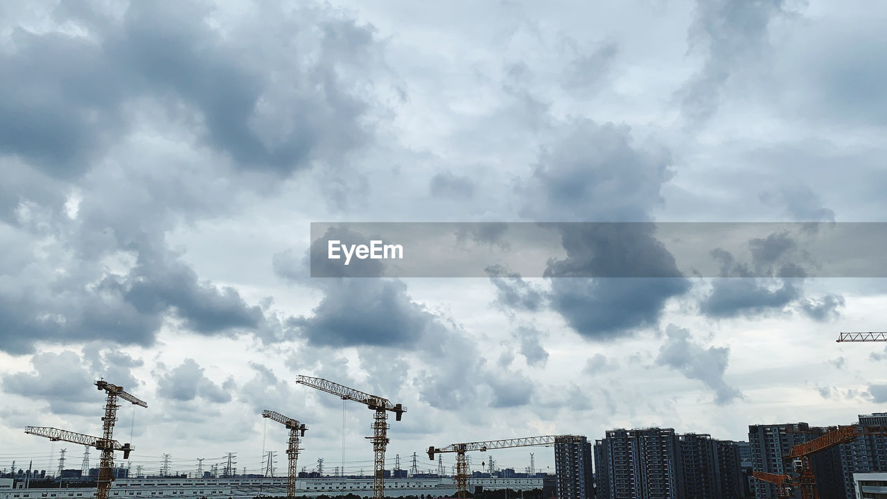 sky, architecture, cloud, crane - construction machinery, industry, machinery, built structure, construction industry, city, building exterior, business, nature, water, pier, harbor, skyline, development, business finance and industry, building, commercial dock, transportation, freight transportation, no people, horizon, outdoors, construction site, sea, cityscape, shipping, skyscraper