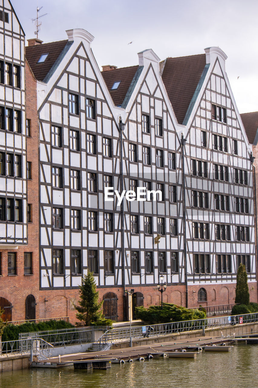 Gdansk, poland may 2022, modern buildings on granary island over the motlawa river in old town