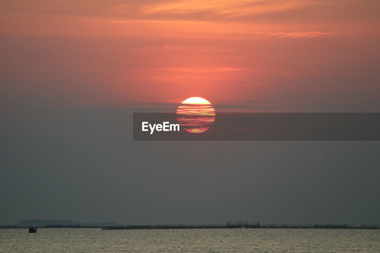 Sunset back onsilhouette red orange sky evening cloud and dark sky over horizon sea