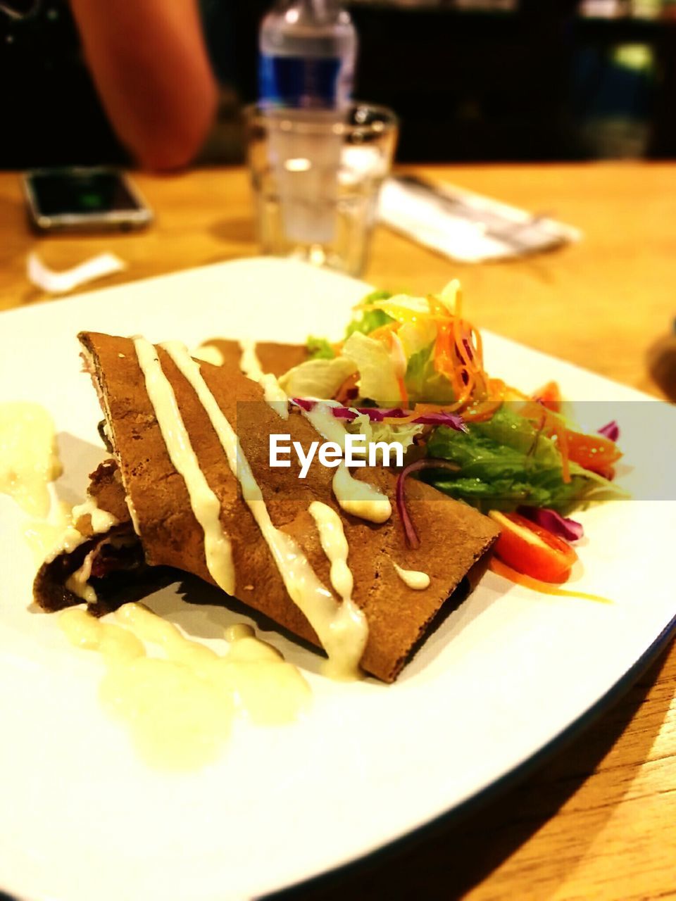 Close-up of crepe served in plate at restaurant table