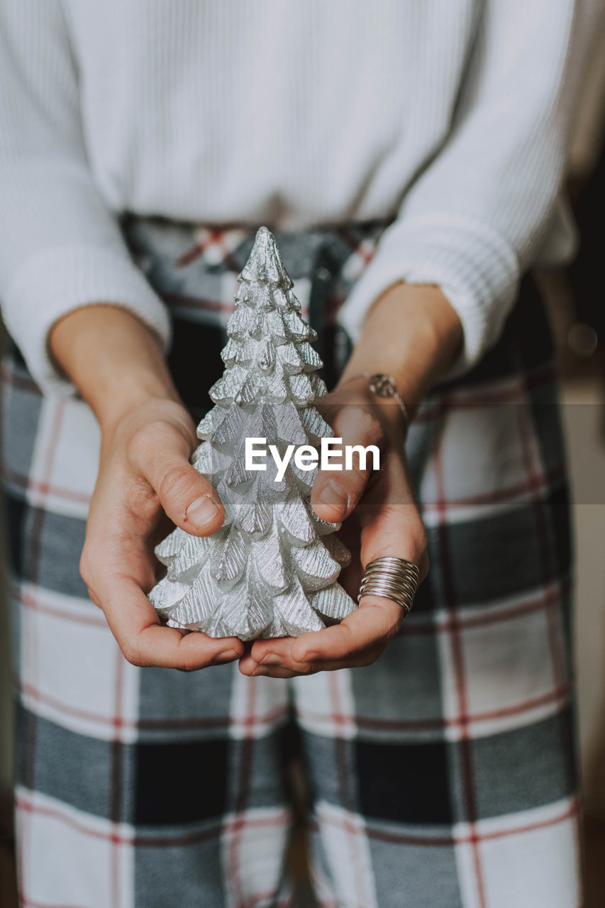 Midsection of woman holding christmas decoration