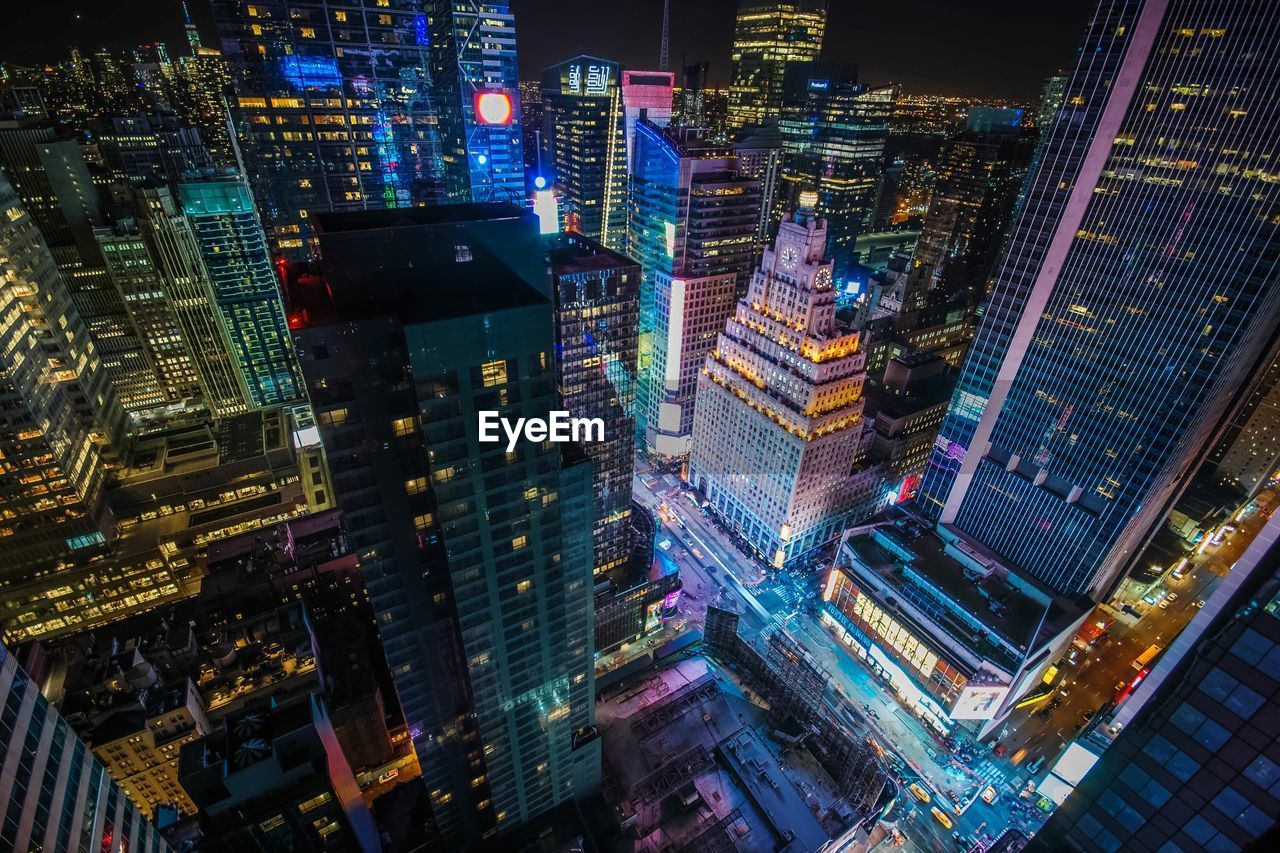 High angle view of city lit up at night