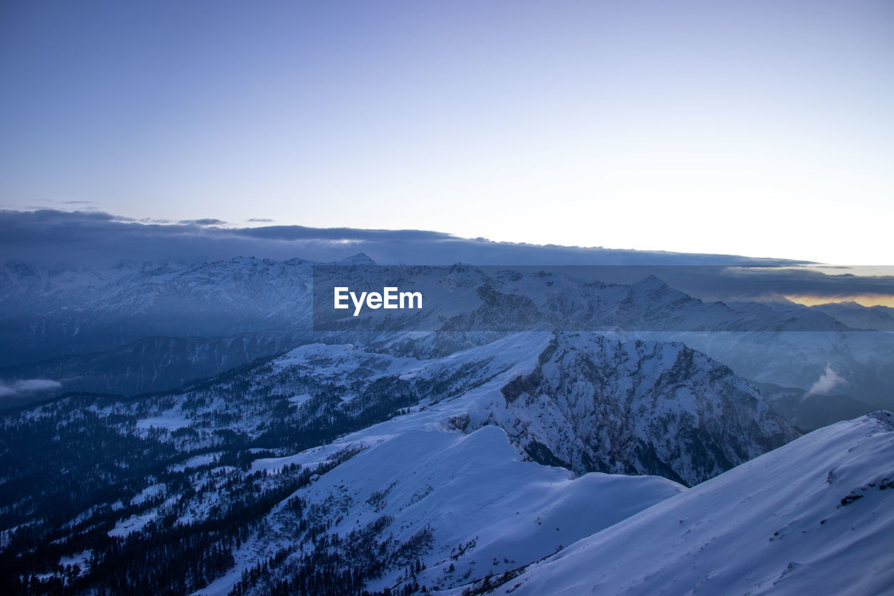 Scenic view of snowcapped mountains against clear sky