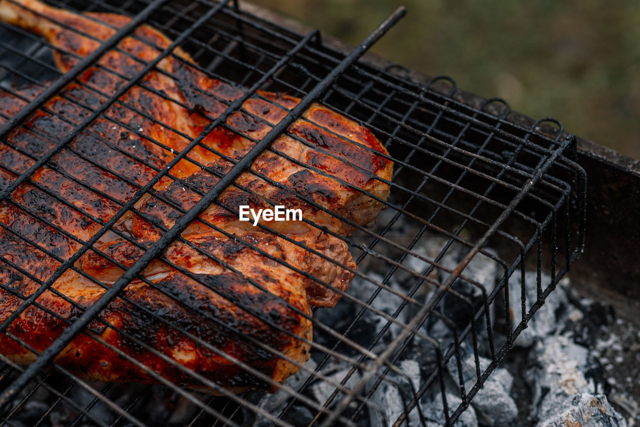 CLOSE-UP OF FIRE ON BARBECUE GRILL