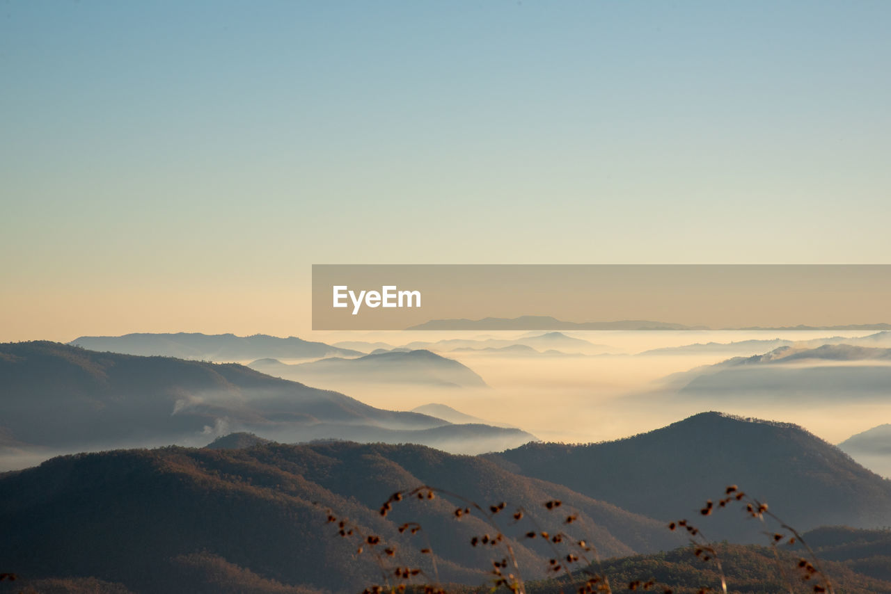 Scenic view of snowcapped mountains against sky during sunset