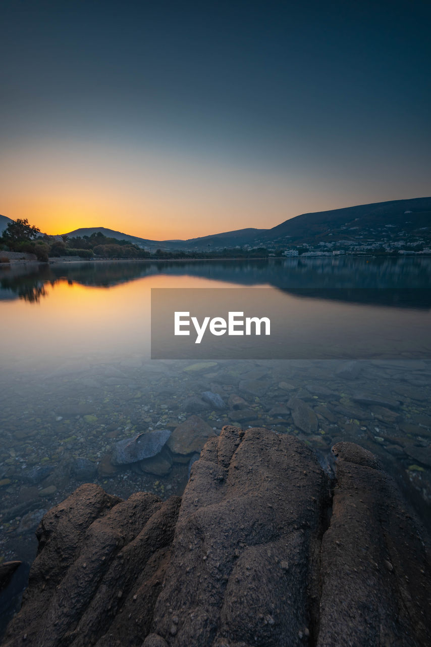 Scenic view of lake against sky during sunset